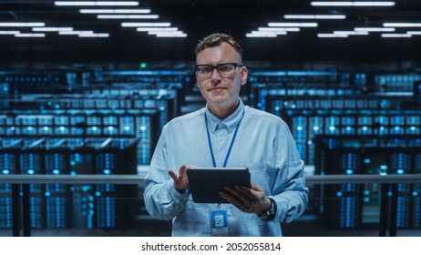 Portrait of a Data Center Engineer Using Laptop Computer. Server Room Specialist Facility with Adult Male System Administrator Working with Data Protection Network for Cyber Security.