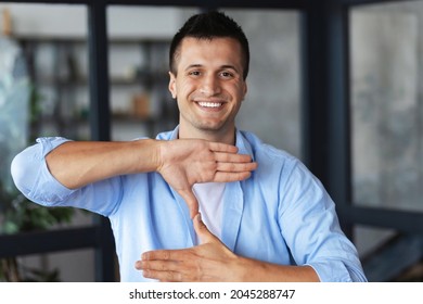 Portrait Of Deaf Or Hard Hearing Caucasian Man Freelancer Or Student Speak In Sign Language, Looking Straight At The Camera, Smiling