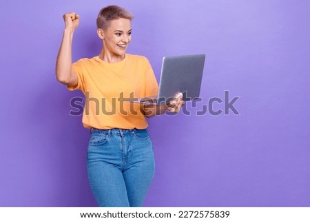 Portrait of delighted positive lady use netbook raise fist luck triumph empty space isolated on purple color background