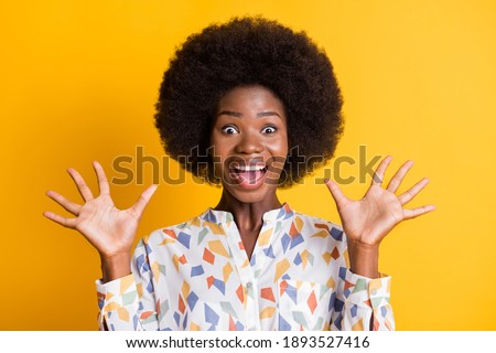 Portrait of delighted positive person open mouth arms palms up great result isolated on yellow color background