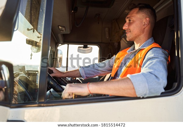 Portrait of delivery driver\
in the car