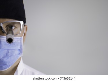 Portrait Of A Dental Surgeon At Work In Surgery On A White Background