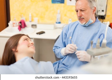 Portrait Of A Dentist Talking To A Patient. Shallow Depth Of Field, Focus On The Man