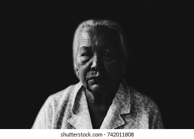 Portrait Of  Depress And Hopeless Elderly Woman Isolated On Black