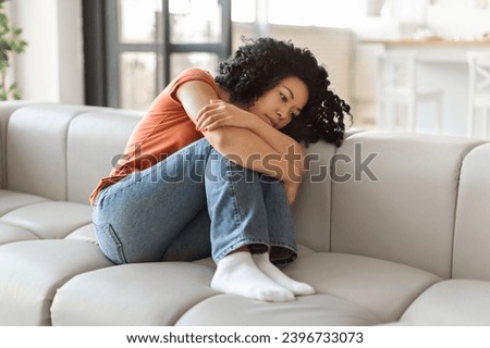 Portrait Of Depressed Black Woman Sitting On Couch At Home, Upset African American Female Suffering Apathy, Brokenhearted Lady Feeling Lonely And Sad While Resting On Sofa, Copy Space