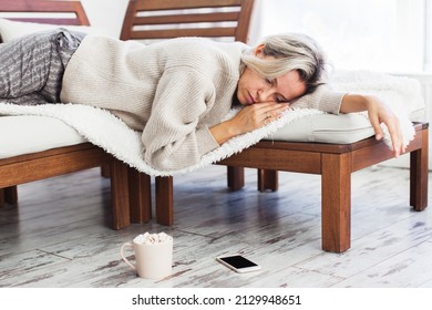 Portrait Of Depressed Middle-aged Woman Feel Upset And Sad After Phone Call, Bad News In Social Media Or Smart Phone Messenger Online App. Frustrated Beautiful Female Sit In Depression On Sofa At Home