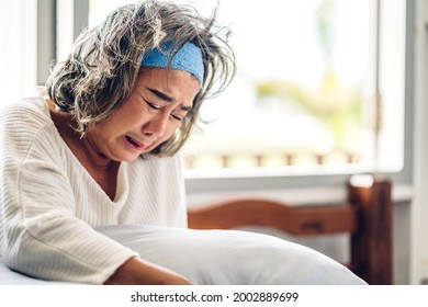 Portrait Of Depressed Senior Old Adult Elderly Sad Stressed Asia Women Crying Alone And Felling Upset On The Bed At Home