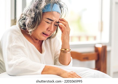 Portrait Of Depressed Senior Old Adult Elderly Sad Stressed Asia Women Crying Alone And Felling Upset On The Bed At Home