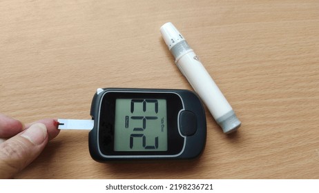 Portrait Diabetes Patient Woman Checking Fingertip, Showing Level High Blood Sugar On Pressure Monitor, Patient Take Proactive Control, Concept Health Care. 