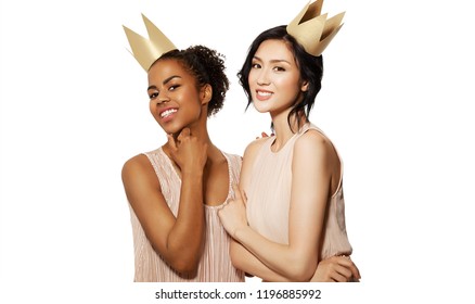 Portrait Of Different Nation Women African-american And Asian Having Funny Time Together Wearing Fake Crowns. Celebrating Concept. Isolated On White Background