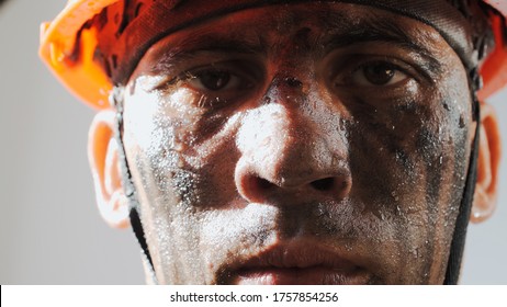 Portrait Dirty Worker Looking At Camera. Sweaty Exhausted Man In A Hard Hat. Filthy Job And Physical Labor. Coal Mining. People Working Equipment. Close Up.