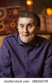 Portrait Of Disabled Man With Cerebral Palsy In Rehabilitation Center.