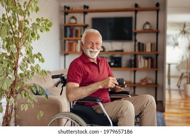 Portrait of disabled mature man, smiling face, holding cup of coffee.