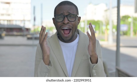 Portrait Of Disappointed African Man Reacting To Loss Outdoor