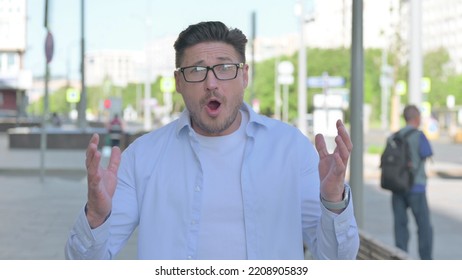 Portrait Of Disappointed Man Reacting To Loss Outdoor