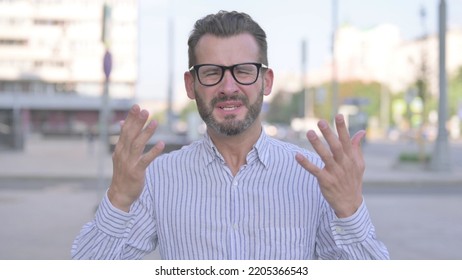 Portrait Of Disappointed Young Adult Man Reacting To Loss Outdoor