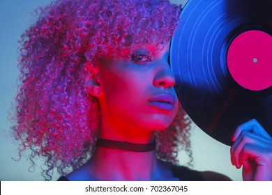 Portrait Of A Disco Woman Holding A Retro Vinyl With Eighties Music And Neon Light