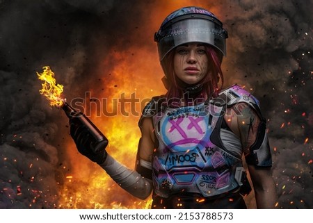 Portrait of displeased woman with tattooed body dressed in armor with graffiti against flame.
