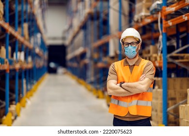 Portrait Of A Distribution Center Worker Standing With Arms Crossed And Looking At The Camera During Corona Virus Pandemic.