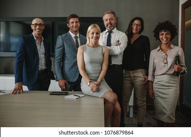 Portrait Of Diverse Business Professionals Together In Office Meeting Room. Team Of Corporate Professionals Looking At Camera And Smiling In Board Room.