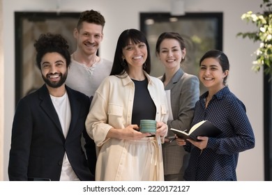 Portrait of diverse businesspeople, five bank employee, multiethnic company staff members in formal wear pose standing together in office hallway. Business leadership, professional management, success - Shutterstock ID 2220172127