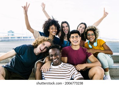 Portrait Of Diverse College Friends Sitting On City Stairs - Happy Multiracial Group Of Young People Having Fun And Relaxing In The Street - Friendship, Youth And Back To University Concept - Focus On