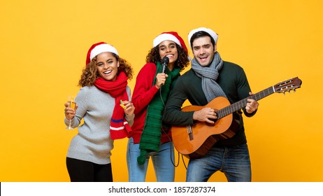 Portrait of diverse friends having party singing drinking and celebrating Christmas on yellow isolated background - Powered by Shutterstock