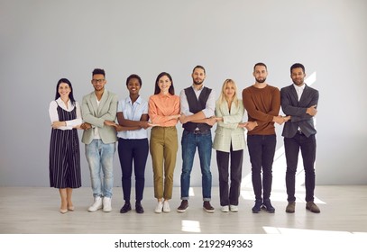 Portrait Of Diverse Multiracial Employees Hold Hands Show Team Unity And Integrity In Office. Smiling Multiethnic People Feel United At Workplace, Involved In Teambuilding. Business, Teamwork.