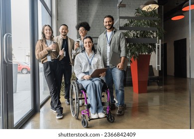 Portrait of diverse startup team looking at camera and posing in office, wheelchair user, inclusion - Powered by Shutterstock