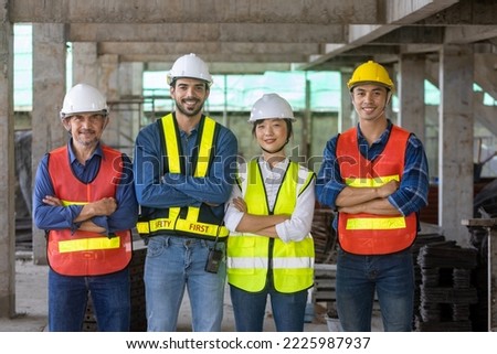Portrait of the diversity team of engineer, architect, worker and safety manager smiling together at the construction site wearing safety vest and helmet 