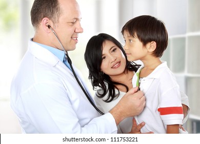 Portrait of a doctor examining youthful patient with stethoscope