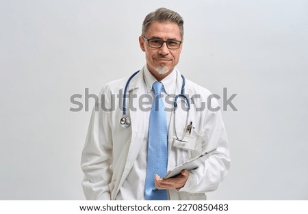 Portrait of doctor, general practitioner, physician, medical professional with tablet on white, Mid adult, mature age man with gray hair, happy smiling.