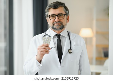 Portrait Of Doctor Holding Box Of Pills