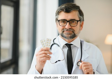 Portrait Of Doctor Holding Box Of Pills