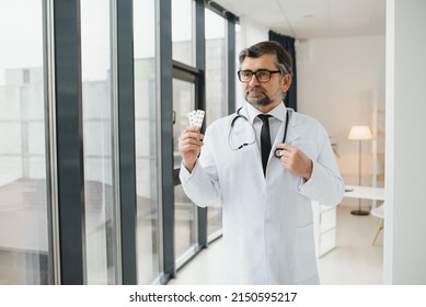 Portrait Of Doctor Holding Box Of Pills