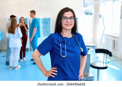 Portrait Of A Doctor Intern. Medical Students Profession Staff. Multinational People - Doctor, Nurse And Surgeon. A Group Of Graduates Of A Medical University In A Surgical Room. Nursing School