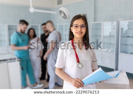 Portrait of a doctor intern. Medical students profession staff. multinational people - doctor, nurse and surgeon. A group of graduates of a medical university in a surgical room. Nursing School