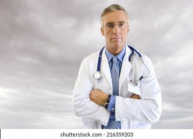 Portrait Of Doctor In Lab Coat With Overcast Sky In Background