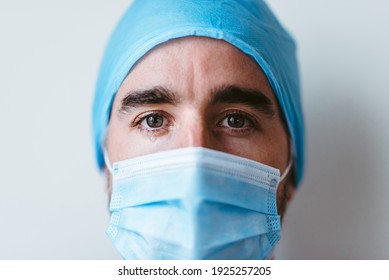 Portrait Of A Doctor With Mask And Uniform Looking To The Camera