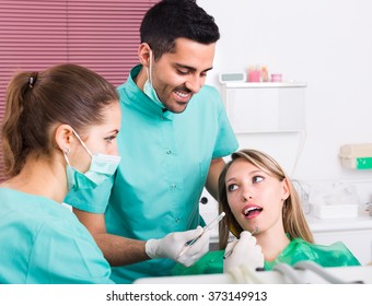 Portrait Of Doctor And Positive Patient 25-35 Years Old At Dental Clinic