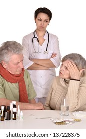 Portrait Of Doctor And Sick Older Caucasian Couple Over White Background