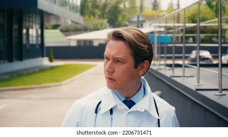 Portrait Of Doctor With Stethoscope Looking Away Outdoors