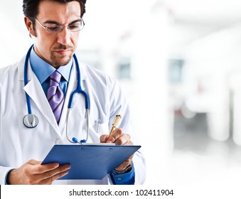 Portrait Of A Doctor Writing A Prescription