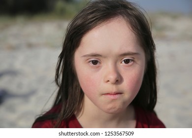 Portrait Of Down Syndrome Girl Outside