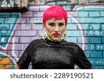 Portrait of drag queen with pink hair looking at the camera