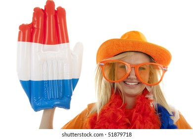 Portrait Of Dutch Soccer Fan In Orange Outfit With Big Glasses, Hat And Big Hand Over White Background