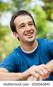 Portrait Of An Early 20s Young Man College Student Outdoors At A Park