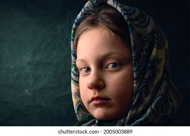 Portrait Of An Eastern European Little ,she Is Wearing A Headscarf And She's Looking At Camera 