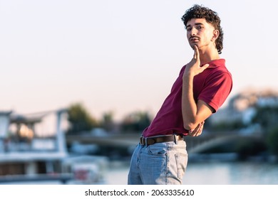 Portrait Of An Effeminate Young Man With Modern Look Next To An Urban River