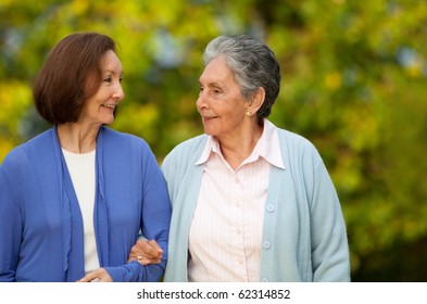 Portrait Of An Elder Mother And Daughter Walking Outdoors